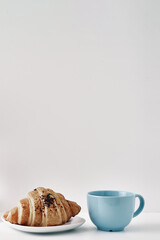 Mug and croissants on a white background. Eco-friendly and natural materials in the decor, dessert. Copy space, mock up