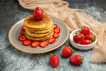 front view yummy pancakes with fresh strawberries on light background sweet cake fruit
