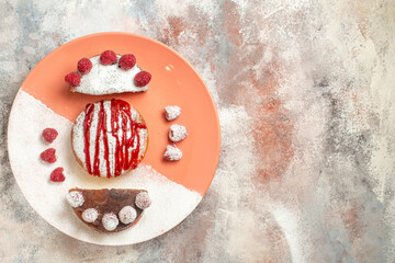 top view of sweet dessert with sauce on it and berries side on with free place for text on orange marble background