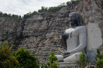 Fototapeta na wymiar A monk made of stone.Buddha.cliff