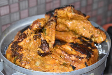tasty spicy tandoori chicken meat marinated in yogurt masala spices roasted in hot pan vessel ready to cook in oven indian famous recipe