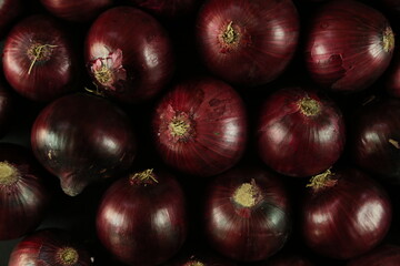 sweet red onions on background