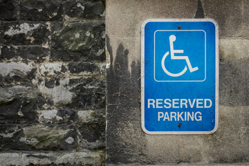 Reserved parking sign on a historic wall in London.