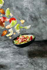 Caesar salad with flying ingredients