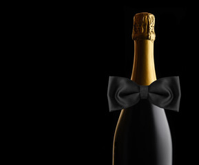 Unopened bottle of Champagne against a black backgroundWith Black Bow Tie. Ideal for Wedding, Anniversary or New Years Projects. © Steve Cukrov