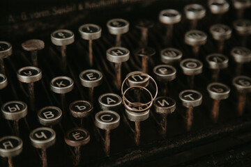 Wedding rings on the keys of a typewriter
