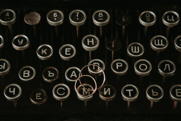 Wedding rings lie beautifully on the typewriter