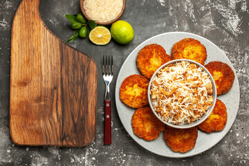 top view delicious fried cutlets with cooked rice on a dark background rissole meat dish