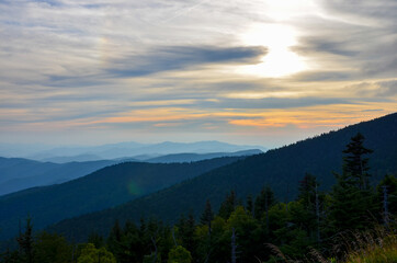 Fototapeta na wymiar Great Smoky Mountains National Park in North Carolina at sunset, different high mountain ranges, orange evening sky background