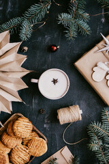 Winter composition with cookies and coffee on a black background. Flat top view