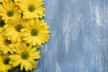 Flowers over painted wooden table. Flowers background for text. Floral background, flower border. Blossom flowers.