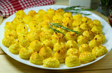 Duchess French potato dish. Cooked side dish for dinner. Mashed potatoes on a white plate.