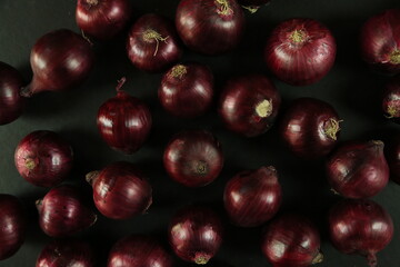 sweet red onions on background