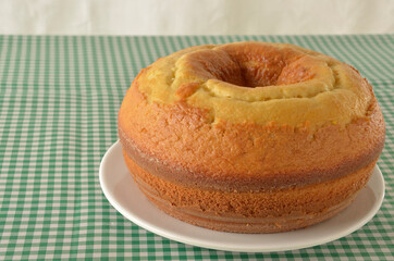 cake on table with green checkered tablecloth