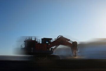 blurred view of big excavator at worksite of coal mine