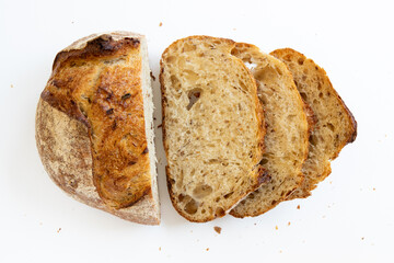 Loaf bread with slices bread on white background top view.