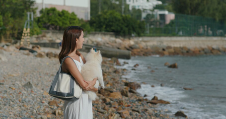 Woman enjoy the sunset view with her dog