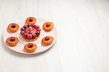 front view delicious cakes with grapes on a white background biscuit pie dessert
