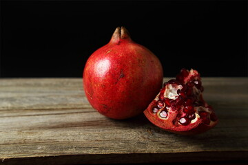 fresh red pomegranate isolated in black background