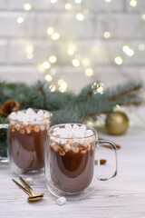 Two glass cup of cocoa on the buckground of gold bokeh, New Year hot drink