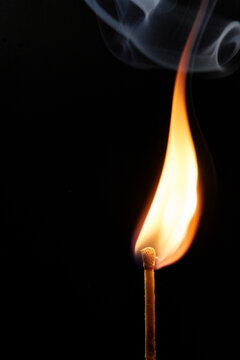 burning a match with a black background
