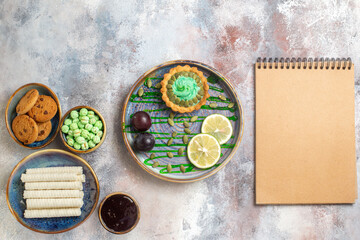top view little cake with fruits and candies on a light background dessert sweet biscuit
