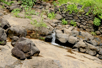 Fototapeta na wymiar areal view of Small waterfall ,Water is coming out of small rock
