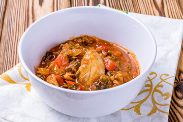Chakhokhbili chicken Georgian cuisine on wooden table