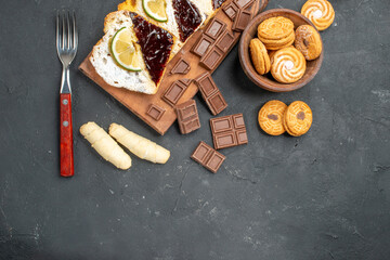 top view cake slices with cookies and chocolate on dark background sweet cake dessert pie
