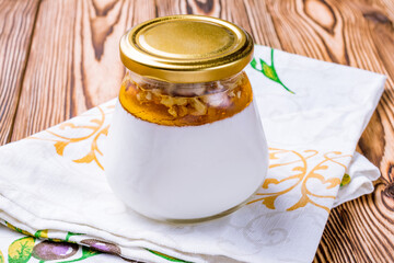 matsoni with honey and nuts on wooden table georgian cuisine