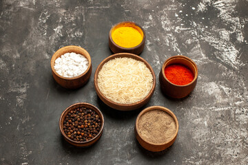 Fototapeta na wymiar top view raw rice with seasonings on dark background spice raw food pepper