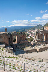 View of part of the Greek-Roman Theater with Taormina in the background. Landmark, touristy site. Sicily, Italy.