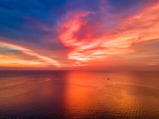 Naklejka na ściany i meble Beautiful red sunset over the ocean.