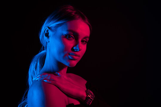 Portrait Of Fashion Young Girl In Red And Blue Neon Light In The Studio.