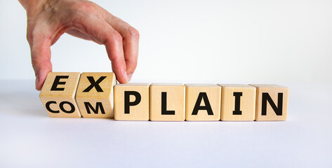 Explain vs complain symbol. Male hand flips wooden cubes and changes the word 'complain' to...
