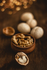 many whole walnuts on a board next to chopped walnuts and walnut kernels on a wooden background