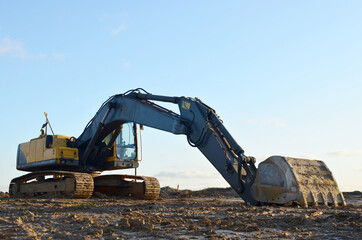 Excavator on earthworks at construction site. Backhoe on foundation work and road construction....