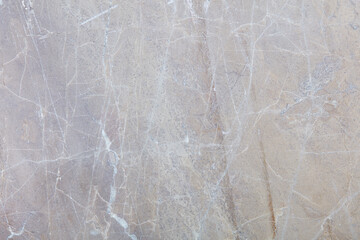 Grey stone surface with scratches and white veins