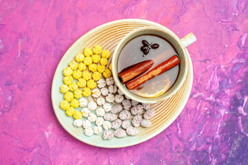 top view cup of tea with sugar candies on pink background sweet color candy