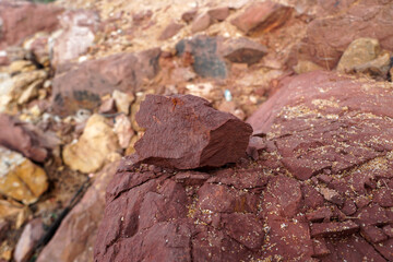 a piece of red shale sedimentary rock on nature background. 