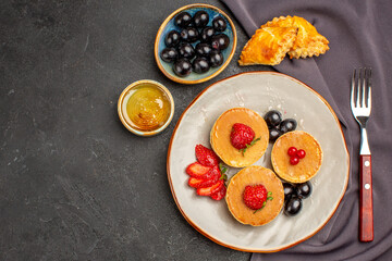 top view yummy pancakes with olives and fruits on dark floor fruit sweet cake