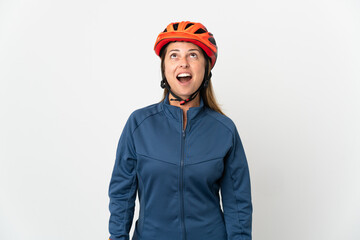 Middle age cyclist woman isolated on white background looking up and with surprised expression