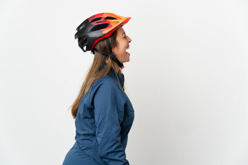 Middle age cyclist woman isolated on white background laughing in lateral position