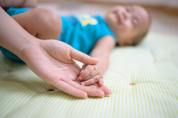 Baby hand in mother hand concept of love and Happiness of maternity.