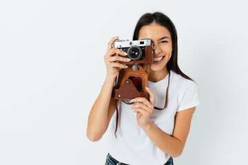 Happy young woman taking pictures on vintage camera