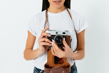 Close-up of a slender woman in holding a retro camera