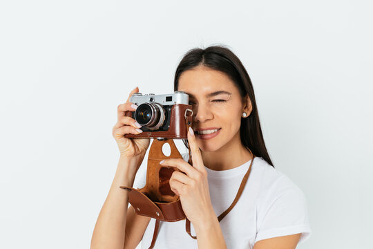 Young woman takes pictures on a retro camera