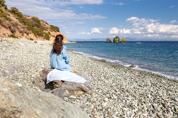 Young woman tourist watching sea landscape, Livadi beach Greece