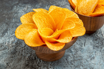 Close up view of delicious homemade potato chips on gray background footage