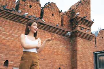 Asian woman traveling at the city wall tha pae gate landmark in Chiang Mai Thailand